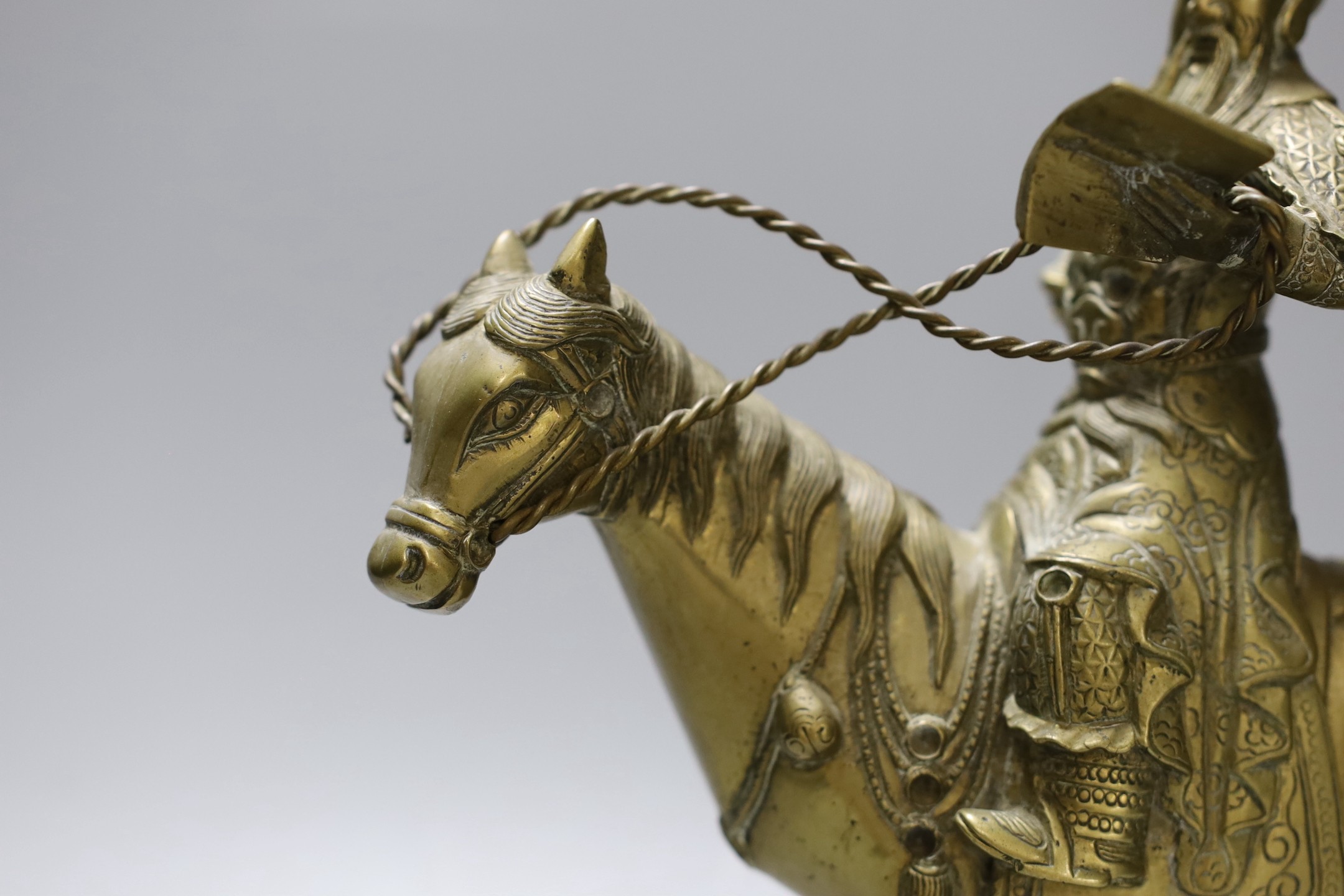 An early 20th century Chinese bronze group of Guandi riding a horse, 24 cms high